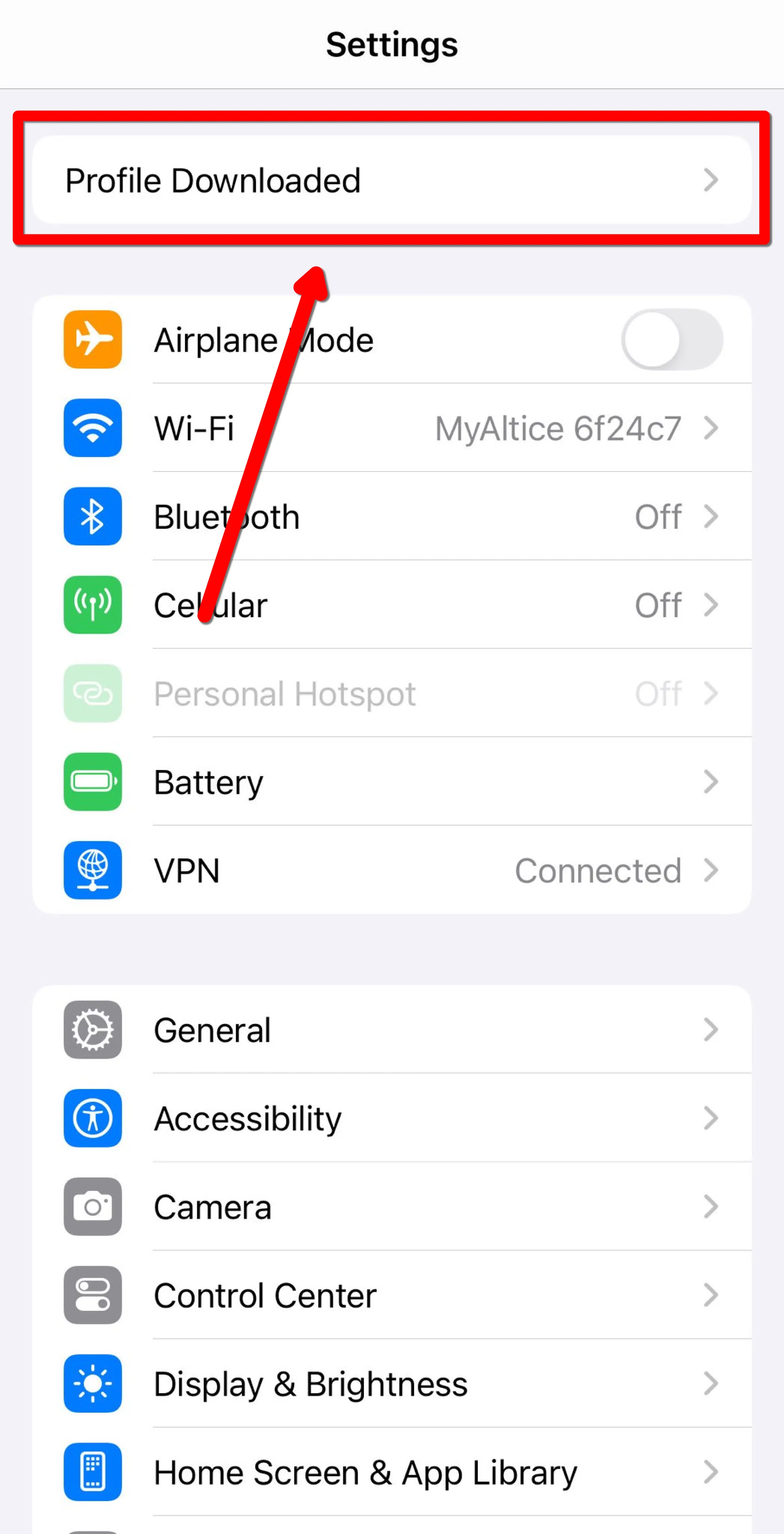 Front page of iOS settings, with an arrow pointing to Profile Downloaded button on top